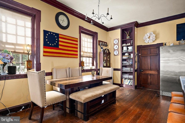 dining area with dark hardwood / wood-style floors and ornamental molding