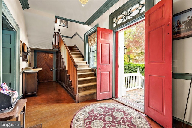 entrance foyer featuring hardwood / wood-style floors and crown molding