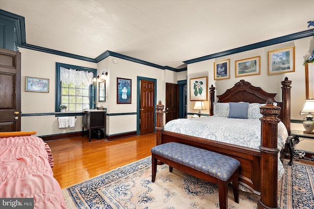 bedroom featuring wood-type flooring and ornamental molding