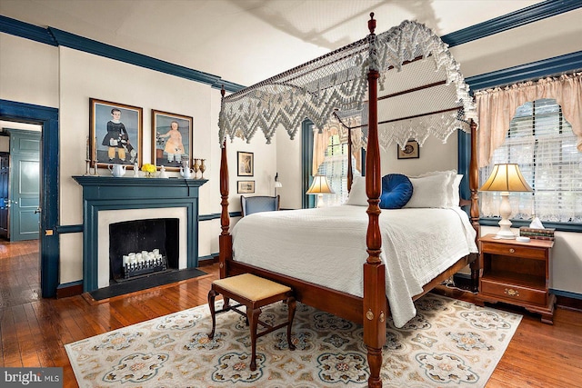 bedroom featuring hardwood / wood-style floors and ornamental molding