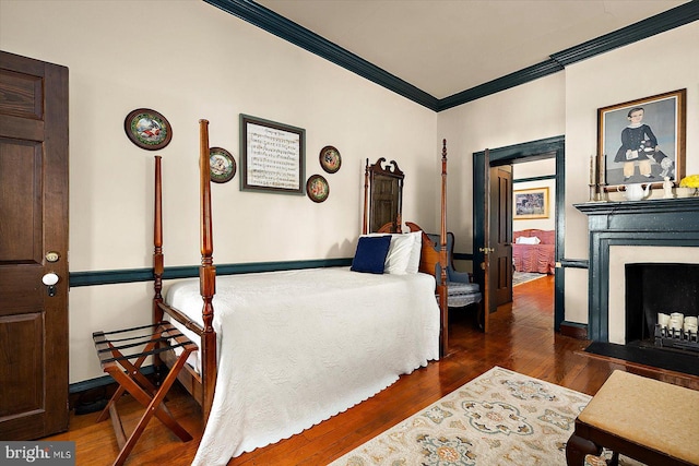 bedroom featuring dark hardwood / wood-style floors and ornamental molding