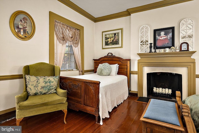 bedroom with dark hardwood / wood-style flooring and crown molding