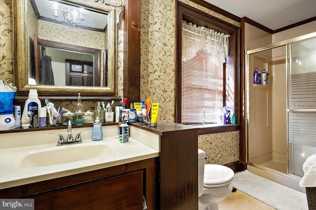 bathroom featuring toilet, an enclosed shower, crown molding, and vanity