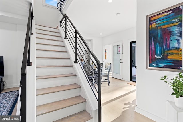 staircase featuring wood-type flooring