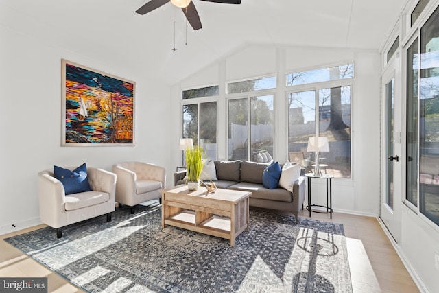 sunroom / solarium with ceiling fan and vaulted ceiling