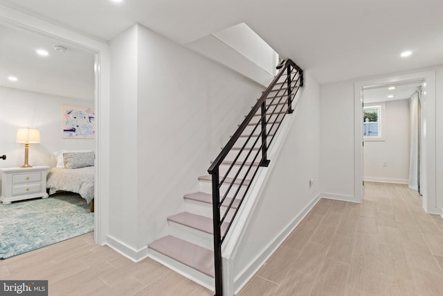 staircase featuring wood-type flooring