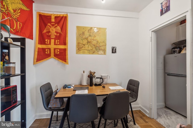 dining room featuring parquet flooring