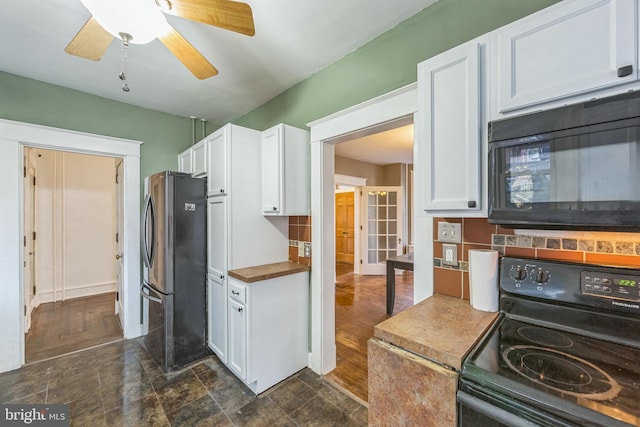 kitchen with decorative backsplash, dark hardwood / wood-style flooring, white cabinetry, and black appliances