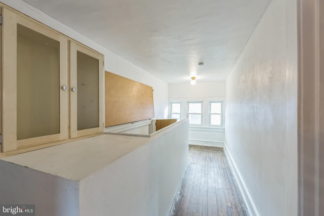 hallway with wood-type flooring