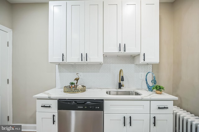 kitchen featuring dishwasher, white cabinetry, radiator heating unit, and sink