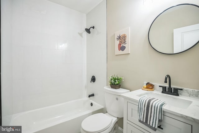 full bathroom with tiled shower / bath, vanity, and toilet