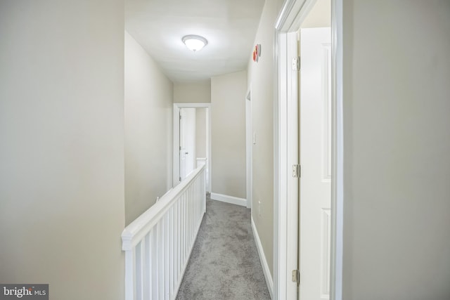 hallway featuring light colored carpet