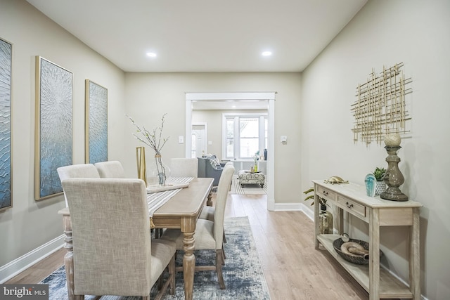 dining space with light hardwood / wood-style floors