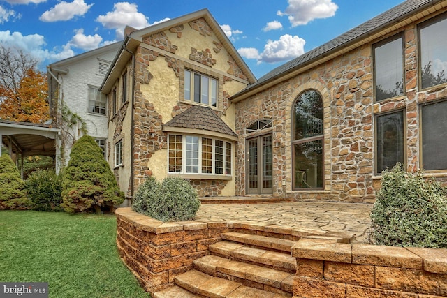 rear view of house featuring a yard