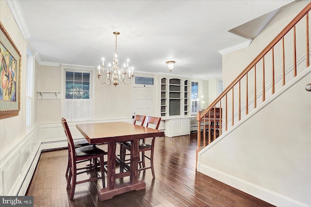 dining area with a notable chandelier, dark hardwood / wood-style floors, and crown molding