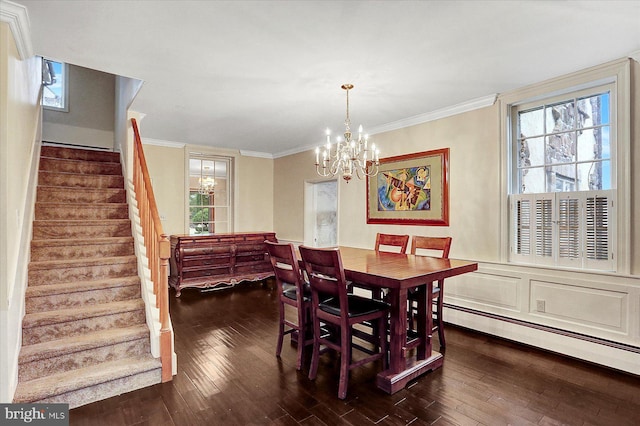 dining space featuring ornamental molding, dark wood-type flooring, a baseboard heating unit, and a notable chandelier