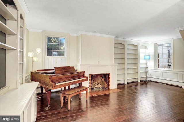 miscellaneous room featuring built in shelves, dark hardwood / wood-style flooring, and crown molding