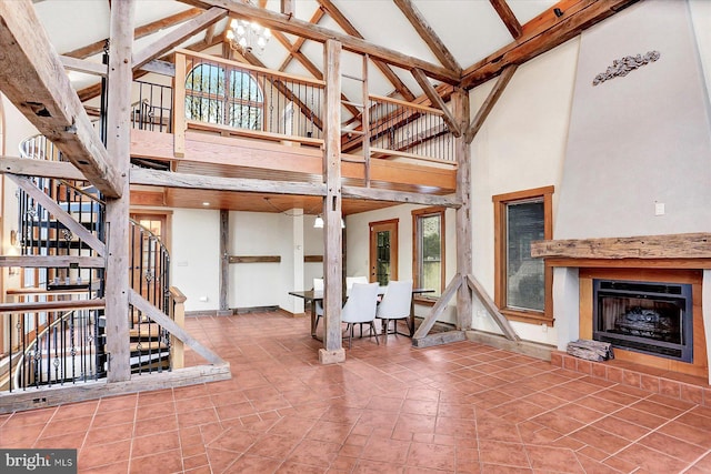 interior space featuring beam ceiling and high vaulted ceiling