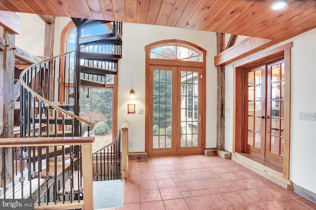 tiled entryway with wooden ceiling and french doors