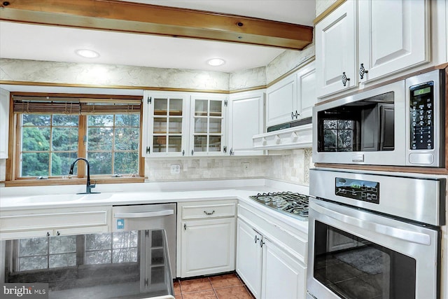 kitchen featuring stainless steel appliances, extractor fan, sink, white cabinets, and wine cooler