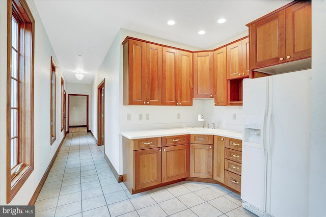 kitchen featuring light tile patterned flooring, a healthy amount of sunlight, and white refrigerator with ice dispenser