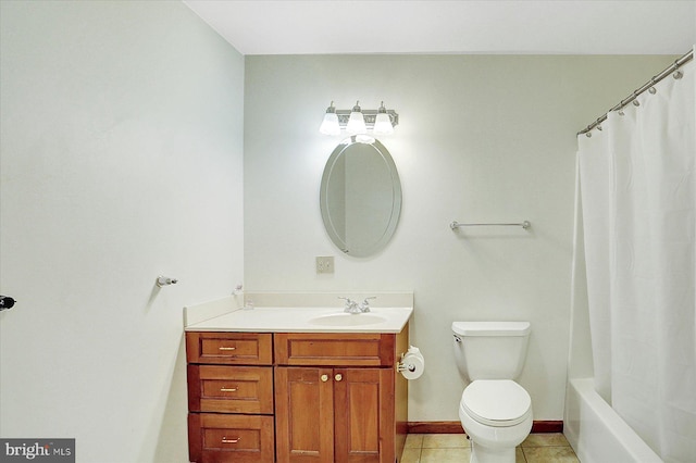 full bathroom featuring tile patterned floors, shower / tub combo with curtain, vanity, and toilet