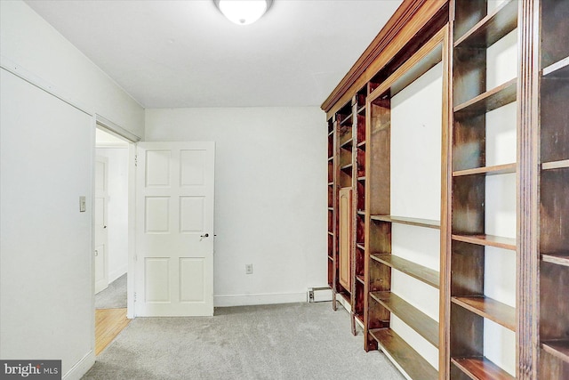 carpeted spare room featuring a baseboard radiator