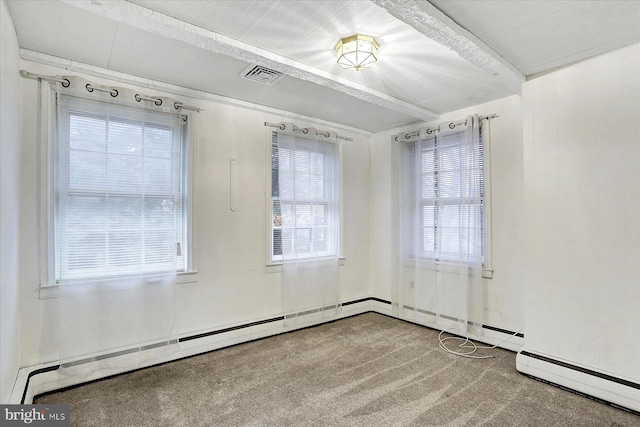 spare room with carpet floors and a baseboard heating unit