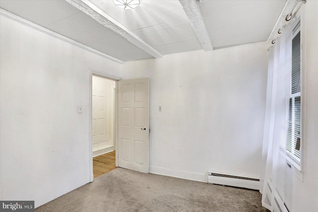 carpeted empty room with beamed ceiling and a baseboard heating unit