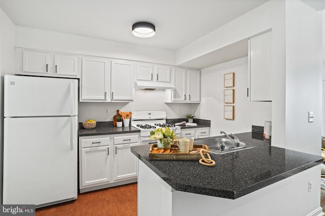 kitchen featuring white appliances, white cabinets, sink, light wood-type flooring, and kitchen peninsula