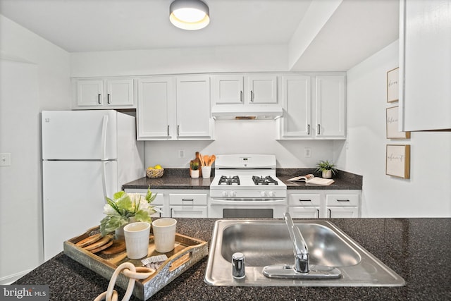 kitchen with white appliances, white cabinetry, and sink