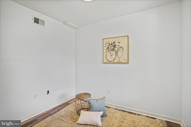 living area with hardwood / wood-style floors