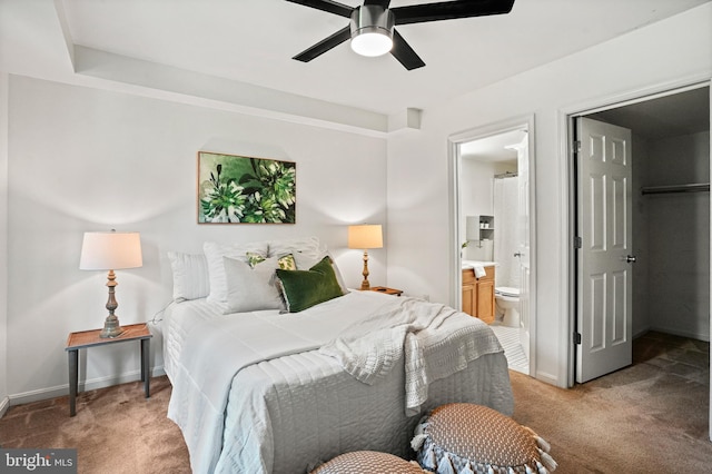 bedroom featuring ceiling fan, carpet floors, and ensuite bath