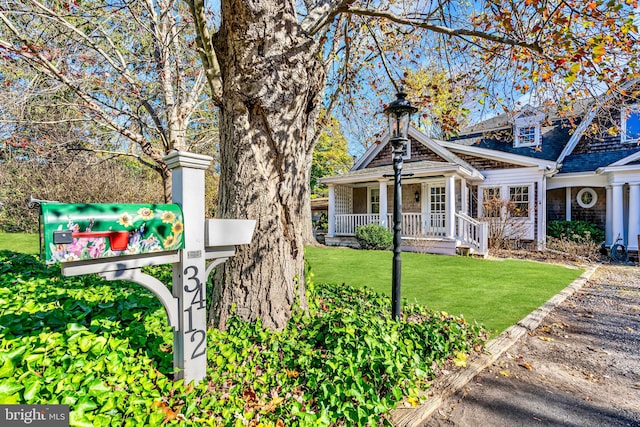 view of front of house with covered porch and a front yard