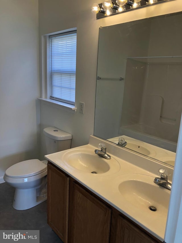 bathroom with walk in shower, vanity, and toilet