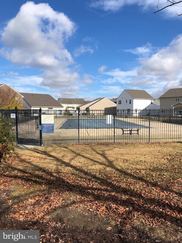 view of pool with a lawn