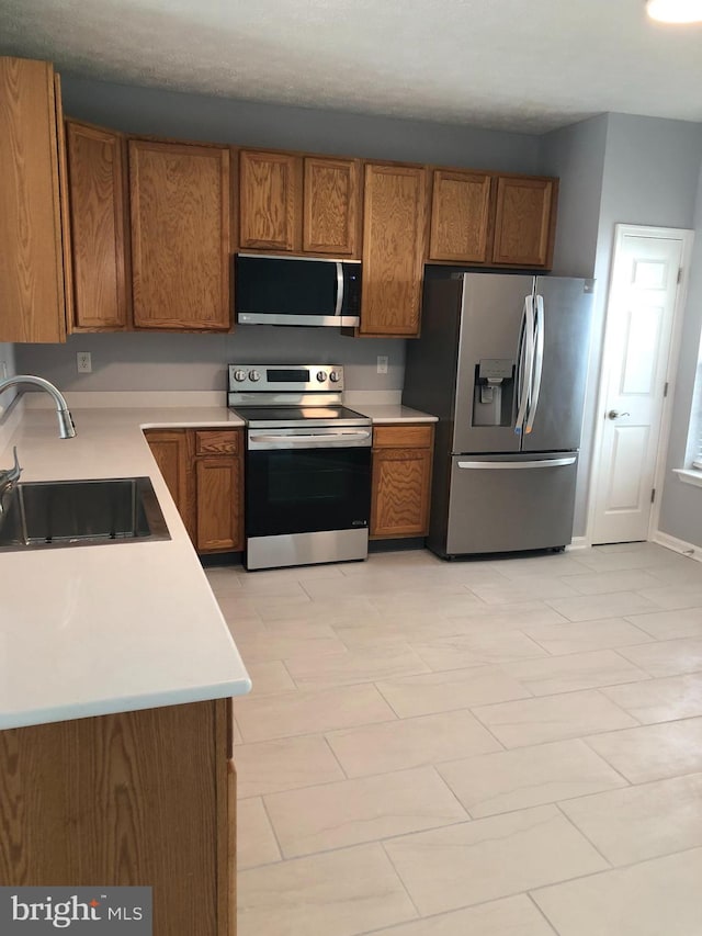 kitchen with sink and appliances with stainless steel finishes