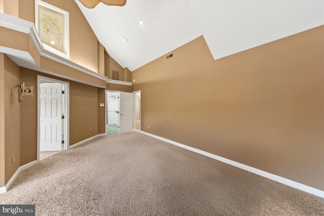 carpeted spare room with baseboards, visible vents, ceiling fan, and high vaulted ceiling