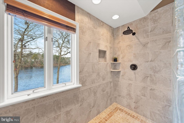 full bath with a water view and tiled shower