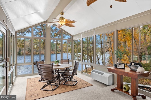 sunroom with a wall mounted air conditioner, a water view, and a ceiling fan