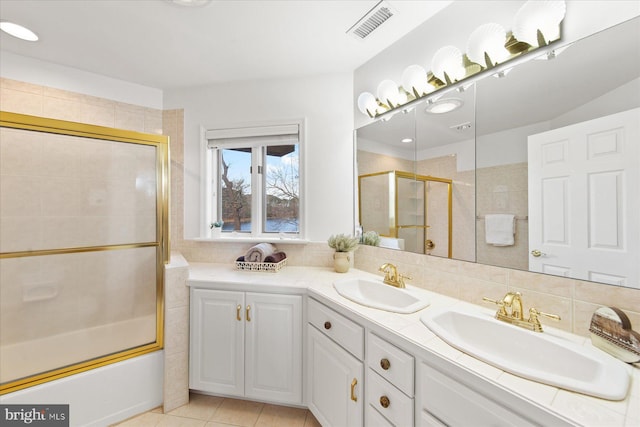 bathroom featuring double vanity, visible vents, tasteful backsplash, and a sink