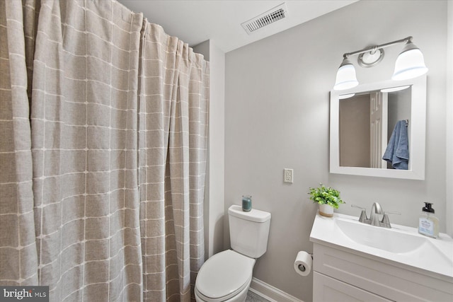 full bath featuring toilet, vanity, baseboards, and visible vents
