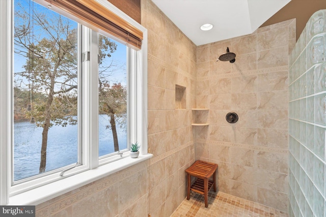 bathroom featuring a water view and tiled shower