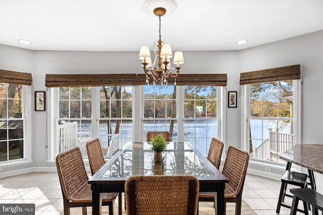 dining room with baseboards, recessed lighting, light tile patterned floors, and a chandelier