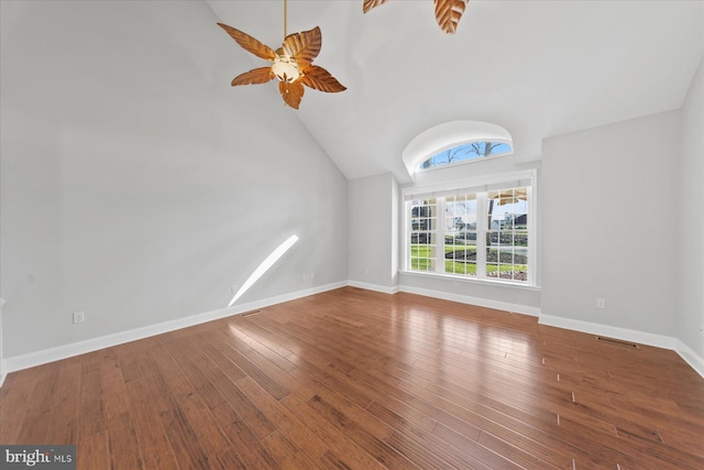 unfurnished room with high vaulted ceiling, wood-type flooring, baseboards, visible vents, and ceiling fan