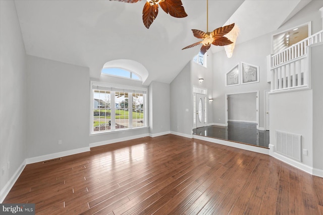 unfurnished living room with baseboards, visible vents, a ceiling fan, and wood-type flooring