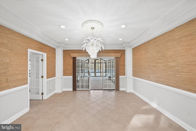tiled spare room featuring baseboards, an inviting chandelier, recessed lighting, and wainscoting