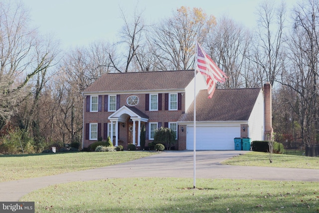 view of front of house featuring a garage and a front lawn