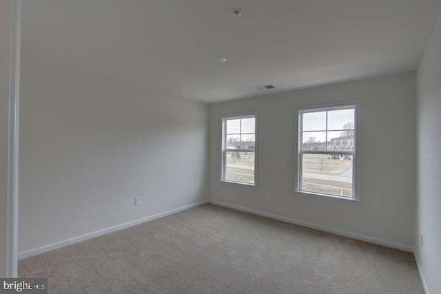 empty room with light colored carpet