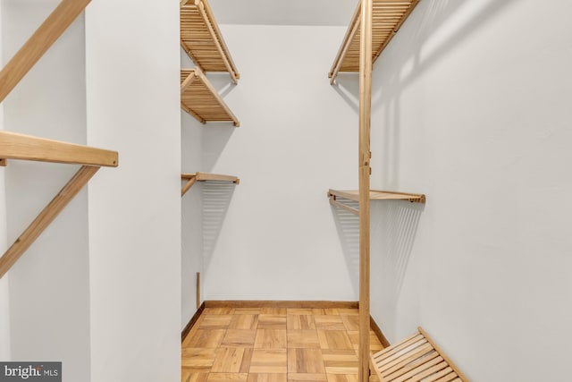 spacious closet featuring light parquet flooring